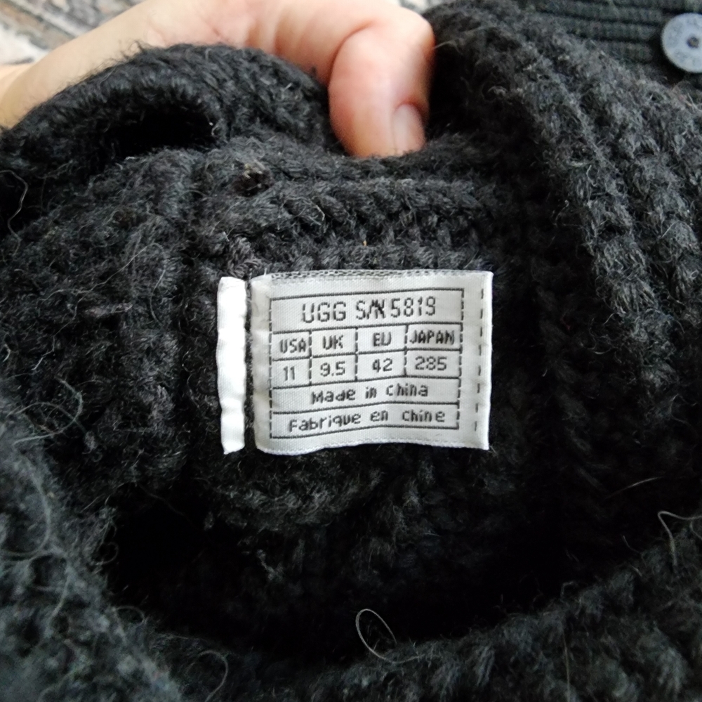 Black knit Ugg boots with buttons.